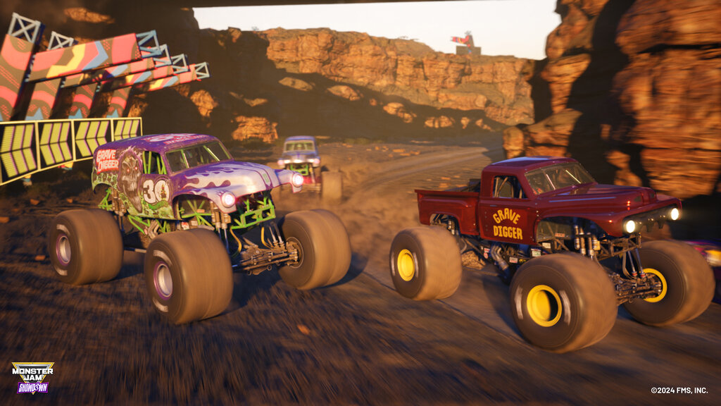 Screenshot aus Monster Jam Showdown. Trucks fahren durch felsige Gegend.