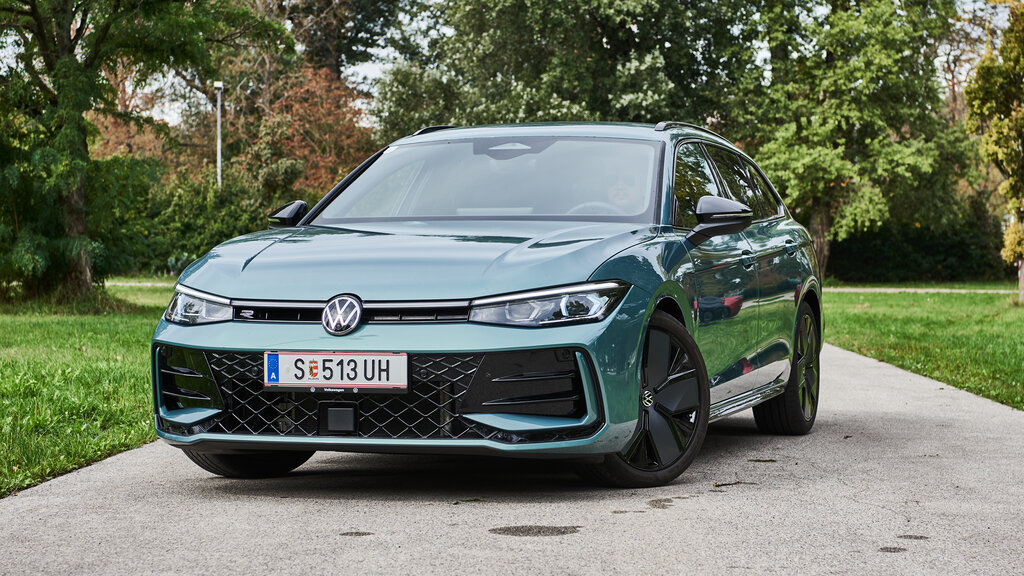 Ein lindgrünes Auto steht in einem Park